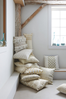 Moroccan magic with vintage kilim pillows and a wedding blanket, called a handira on a bed with giant Berber doors as a headboard. And yes - we did just get in an